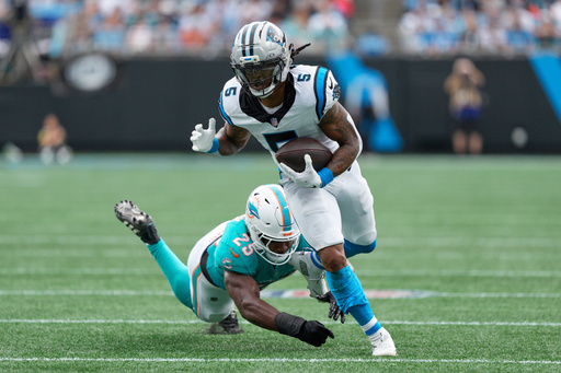 Carolina Panthers running back Rico Dowdle runs past Miami Dolphins linebacker Tyrel Dodson during the first half of an NFL football game, Sunday, Oct. 5, 2025, in Charlotte, N.C. (AP Photo/Jacob Kupferman) Carolina Panthers running back Rico Dowdle runs past Miami Dolphins linebacker Tyrel Dodson during the first half of an NFL football game, Sunday, Oct. 5, 2025, in Charlotte, N.C. (AP Photo/Jacob Kupferman)
