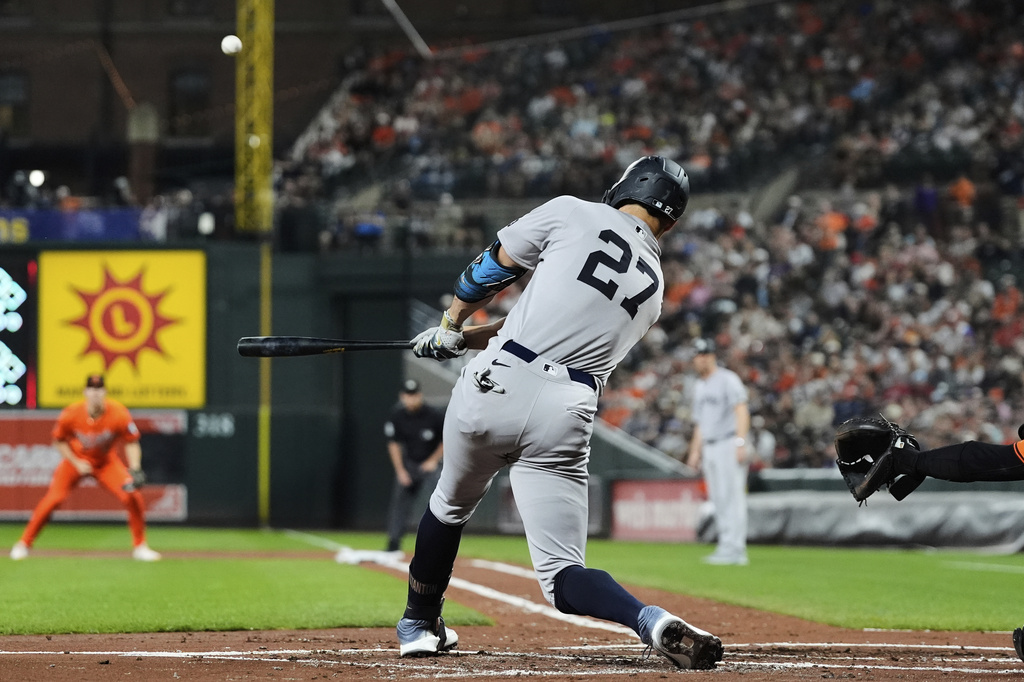 New York Yankees' Giancarlo Stanton hits a three-run home run during the first inning of a baseball game against the Baltimore Orioles, Saturday, Sept. 20, 2025, in Baltimore. (AP Photo/Stephanie Scarbrough)