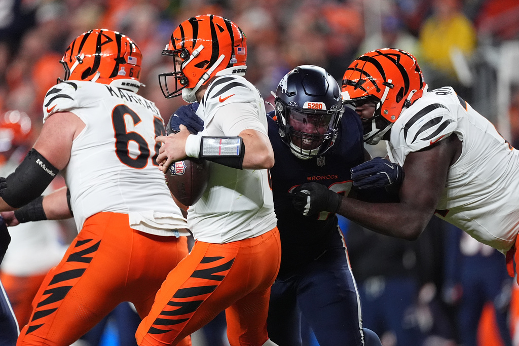 Denver Broncos defensive end John Franklin-Myers (98) sacks Cincinnati Bengals quarterback Jake Browning (6) during the second half of an NFL football game Monday, Sept. 29, 2025, in Denver. (AP Photo/David Zalubowski)