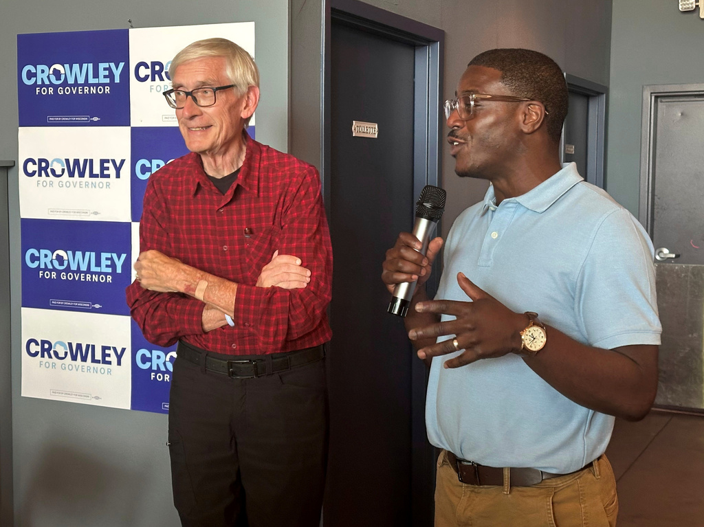 Wisconsin Gov. Tony Evers, left, campaigns with Democratic candidate for Governor David Crowley, right, Monday, Aug. 10, 2026, in Madison, Wis. (AP Photo/Scott Bauer)