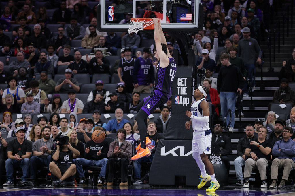 Sacramento Kings center Maxime Raynaud (42) dunks the ball during the first half of an NBA basketball game against the Dallas Mavericks, Tuesday, Jan. 6, 2026, in Sacramento, Calif. (AP Photo/Scott Marshall)