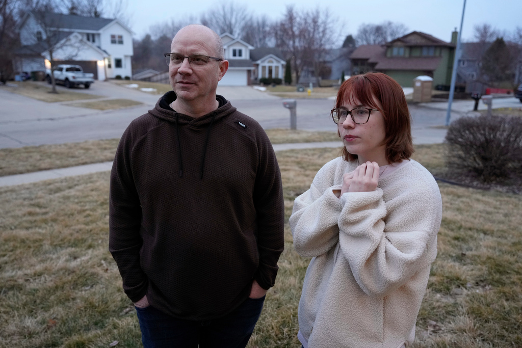 Andrew Coady and his daughter Keira, right, talk about his son, Sgt. Declan Coady, 20, of West Des Moines, Iowa, outside their home, Tuesday, March 3, 2026, in West Des Moines, Iowa. (AP Photo/Charlie Neibergall)