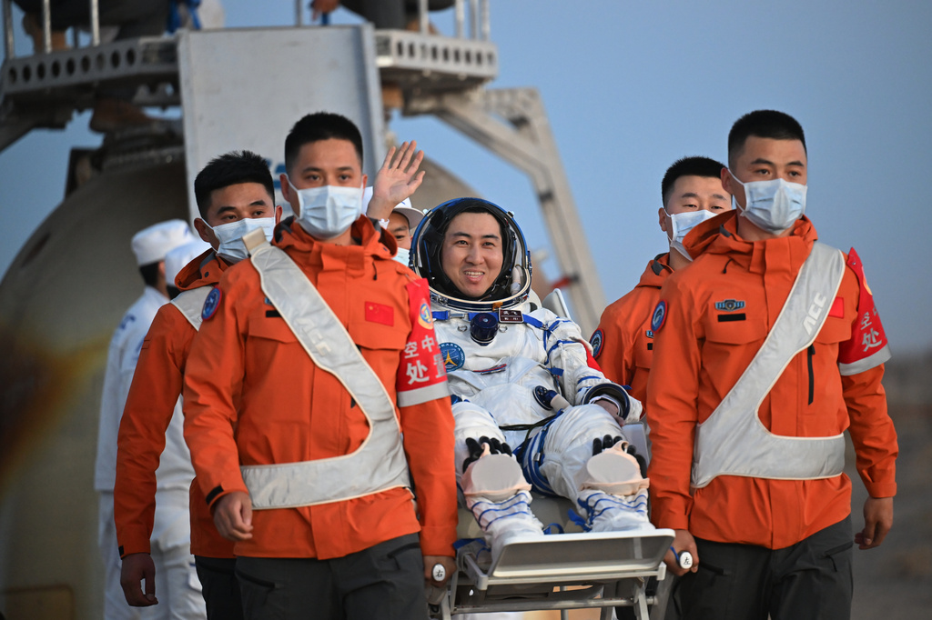 In this photo released by Xinhua News Agency, astronaut Wu Fei waves as he is carried out of the re-entry capsule after it landed successfully at the Dongfeng landing site in northern China's Inner Mongolia Autonomous Region on Friday, May 29, 2026. (Li Zhipeng/Xinhua via AP)