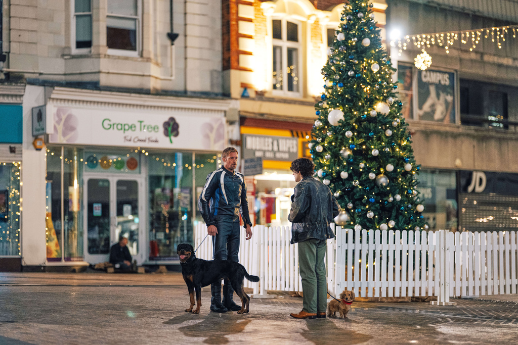 This image released by A24 shows Harry Melling, right, and Alexander Skarsgård in a scene from "Pillion." (Chris Harris/A24 via AP)