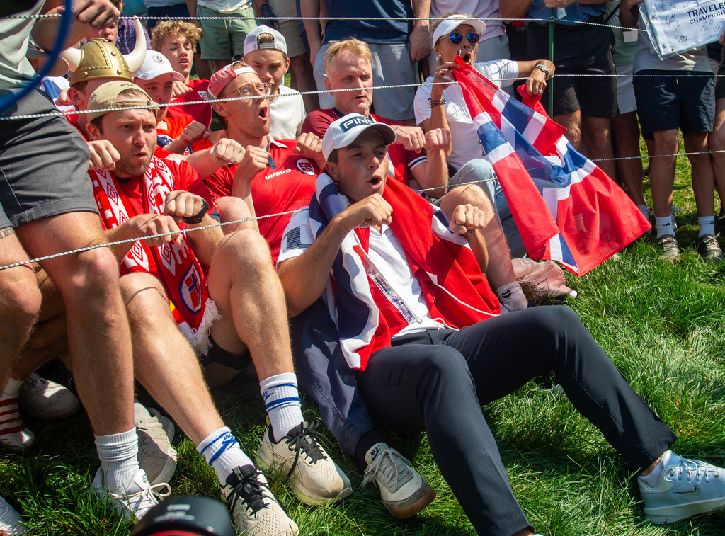 Viktor Hovland celebrates his victory with fellow Norwegians as they do the Viking Row on the 18th green after winning a playoff at the 2026 Travelers Championship at TPC River Highlands in Cromwell, Conn., Monday, June 29, 2026. (Aaron Flaum/Hartford Courant via AP)