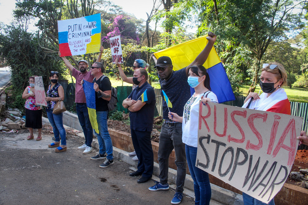 FILE - Protestors hold placards at a small demonstration held by Ukrainians, Russians, and Kenyans against Russia's invasion of Ukraine, in front of the Russian embassy in Nairobi, Kenya Saturday, Feb. 26, 2022. (AP Photo, File)