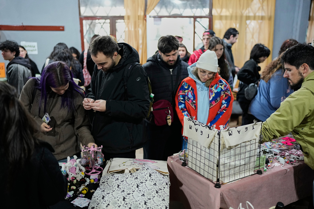People look at stands selling rat merchandise during Ratapalooza, an event promoting the adoption and responsible care of former laboratory rats and mice, in Buenos Aires, Argentina, Sunday, May 17, 2026. (AP Photo/Natacha Pisarenko)