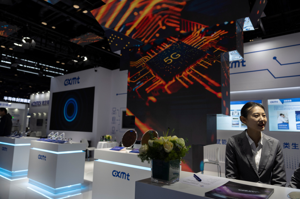 FILE - A worker at the booth for Chinese DRAM producer ChangXin Memory Technologies, also known as CXMT, waits for visitors at the 21st China International Semiconductor Expo in Beijing, Nov. 20, 2024. (AP Photo/Ng Han Guan, File)