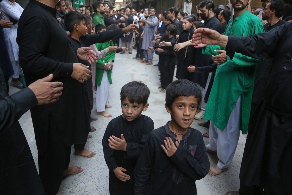 Shiite Muslims beat their chests in a ritual during a procession in the mourning month of Muharram, in Peshawar, Pakistan, Tuesday, June 23, 2026. (AP Photo/Muhammad Sajjad)