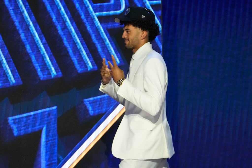 Cameron Boozer gestures as he walks off the stage after being chosen by the Memphis Grizzlies in the first round of the NBA basketball draft, Tuesday, June 23, 2026, in New York. (AP Photo/Yuki Iwamura)