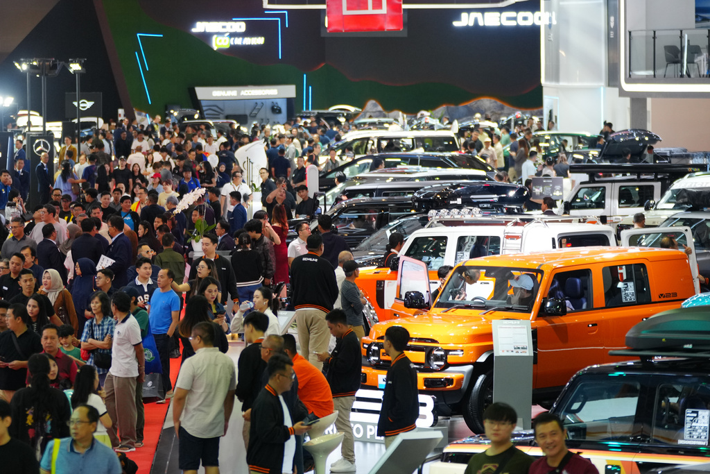 Visitors look at vehicles during a motor show in Jakarta, Indonesia, Feb. 7, 2026. (AP Photo/Tatan Syuflana)
