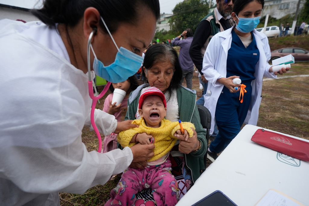 A boy evacuated from Chapula receives medical aid at an improvised shelter in Bella Vista, Hidalgo state, Mexico, Tuesday, Oct. 14, 2025, after torrential rains. (AP Photo/Fernando Llano)