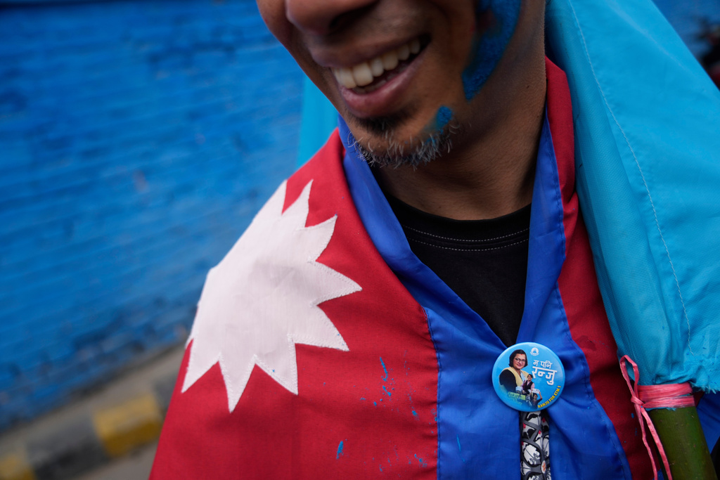 A supporter of Rastriya Swatantra Party celebrates the victory of Ranju Darshana, a candidate for a seat in the House of Representatives in Kathmandu, Nepal, Friday, March 6, 2026. (AP Photo/Niranjan Shrestha)