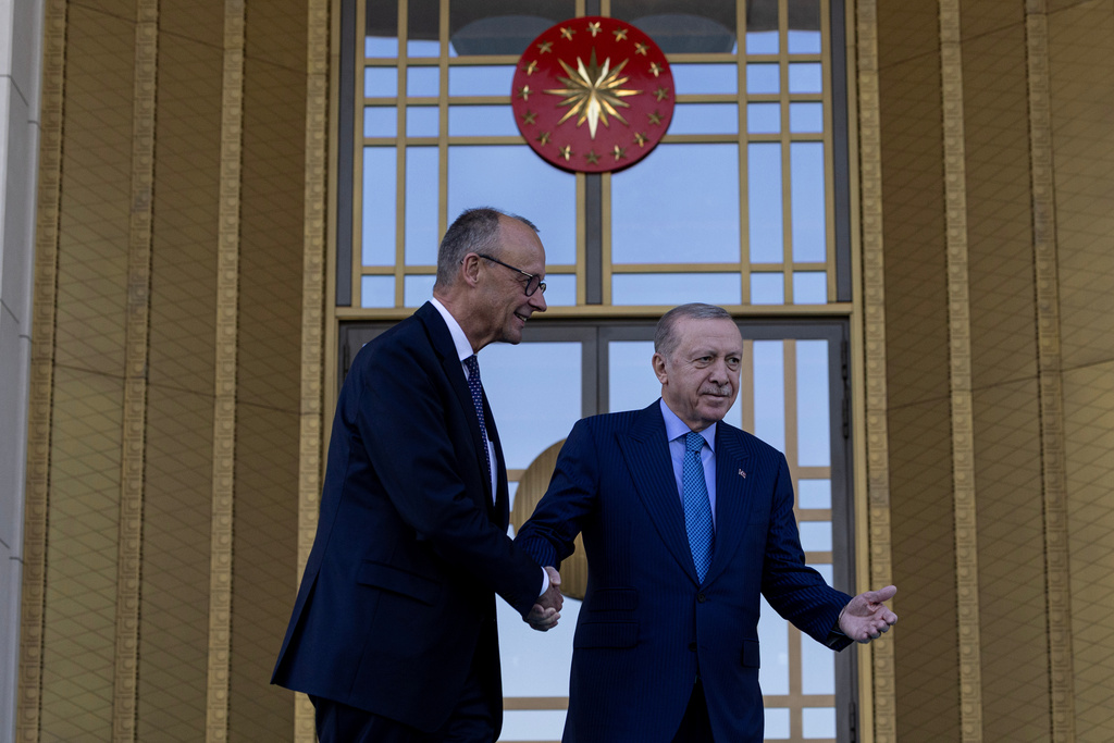 Turkey's President Recep Tayyip Erdogan, right, welcomes German Chancellor Friedrich Merz prior their meeting at the presidential palace in Ankara, Thursday, Oct. 30, 2025. (Ugur Yildirim/Dia Photo via AP)