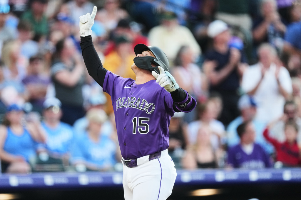 Colorado Rockies' Hunter Goodman gestures as he crosses home plate after hitting a three-run home run off Kansas City Royals starting pitcher Luinder Avila in the third inning of a baseball game Saturday, Aug. 1, 2026, in Denver. (AP Photo/David Zalubowski)