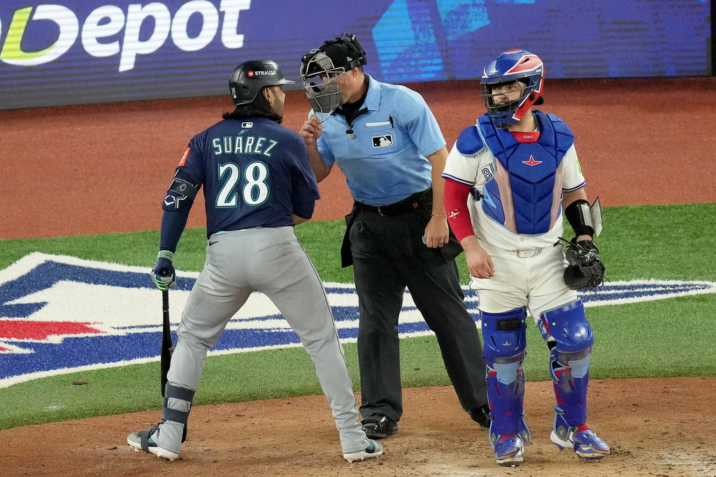 Seattle Mariners third base Eugenio Suárez (28) expresses his anger at the umpire for a called strike during eighth inning MLB American League Championship Series game 7 baseball action against the Toronto Blue Jays, in Toronto, Monday, Oct. 20, 2025. (Chris Young/The Canadian Press via AP)