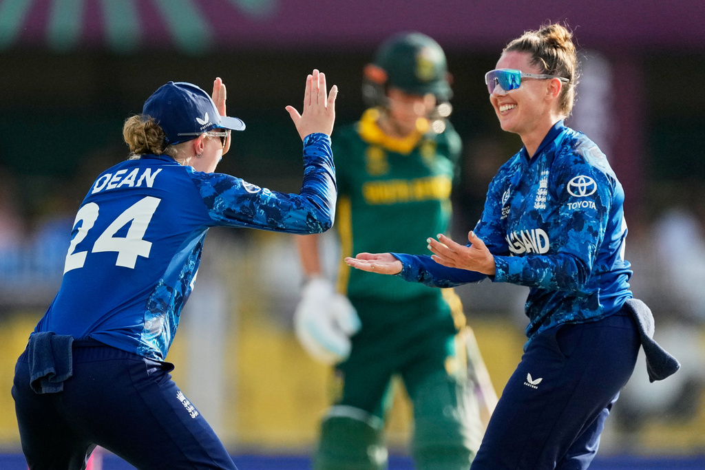 England's Linsey Smith, right, celebrates the dismissal of South Africa's Marizanne Kapp during the ICC Women's Cricket World Cup match between England and South Africa at Barsapara Cricket Stadium in Guwahati, India, Friday, Oct. 3, 2025. (AP Photo/Anupam Nath)
