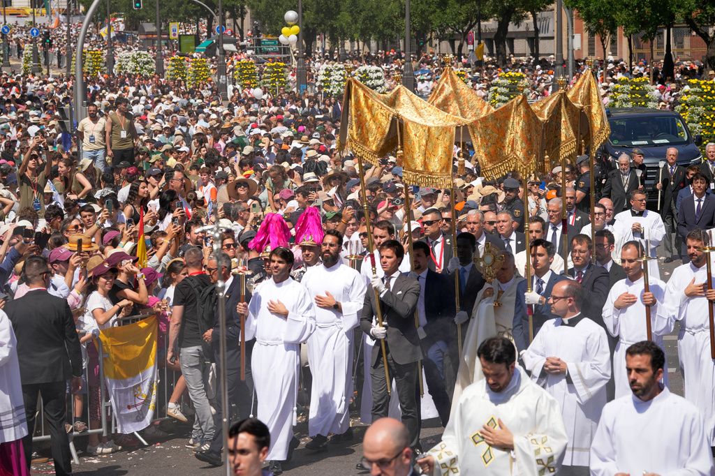 Pope Leo XIV takes part in a procession marking the Catholic feast of Corpus Christi at Plaza de Cibeles in Madrid, Spain, Sunday, June 7, 2026, on the second day of his seven-day apostolic visit to mainland Spain and the Canary Islands. (AP Photo/Bernat Armangue)
