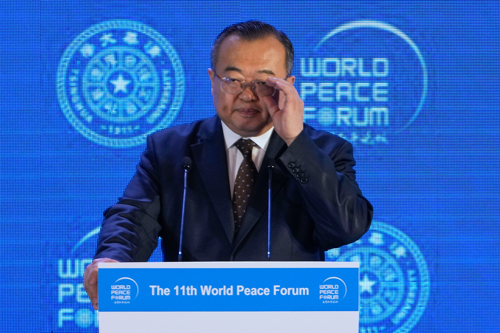 FILE - Liu Jianchao, Minister of the International Department of the Chinese Communist Party Central Committee adjusts his glasses during a Q&A session for a lunch meeting of the 11th World Peace Forum at a hotel in Beijing, July 2, 2023. .(AP Photo/Andy Wong, File)