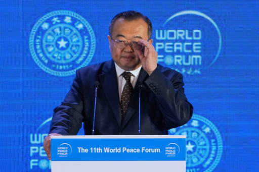 FILE - Liu Jianchao, Minister of the International Department of the Chinese Communist Party Central Committee adjusts his glasses during a Q&A session for a lunch meeting of the 11th World Peace Forum at a hotel in Beijing, July 2, 2023. .(AP Photo/Andy Wong, File) FILE - Liu Jianchao, Minister of the International Department of the Chinese Communist Party Central Committee adjusts his glasses during a Q&A session for a lunch meeting of the 11th World Peace Forum at a hotel in Beijing, July 2, 2023. .(AP Photo/Andy Wong, File)