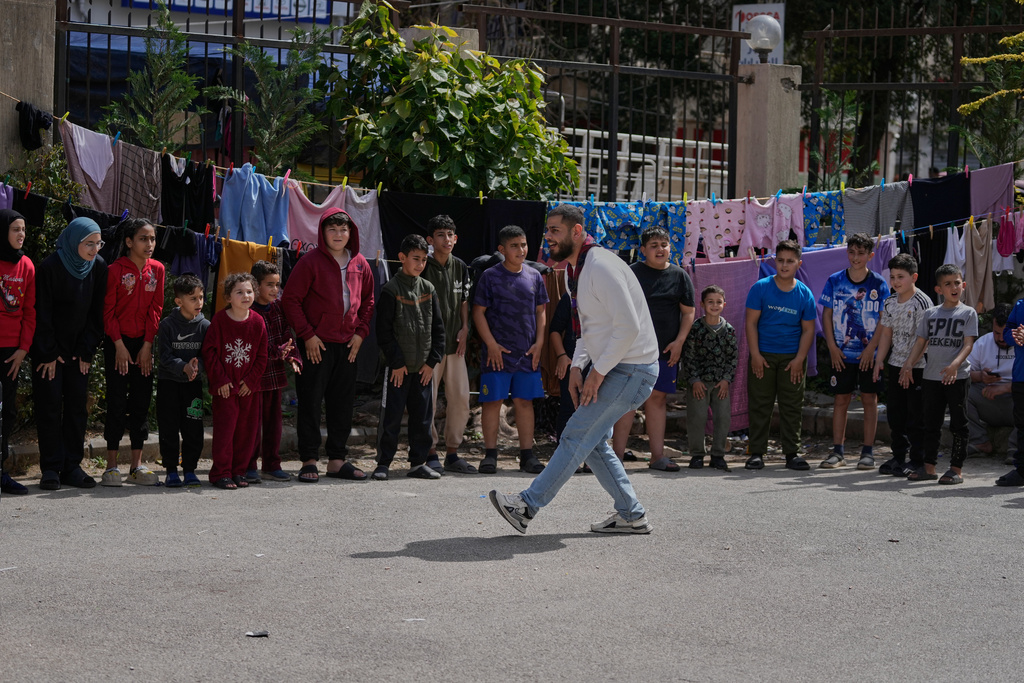 Displaced children who fled Israeli strikes from south Lebanon, take part in activities at a school turned shelter, in the southern port city of Sidon, Lebanon, Wednesday, March 18, 2026. (AP Photo/Mohammed Zaatari)