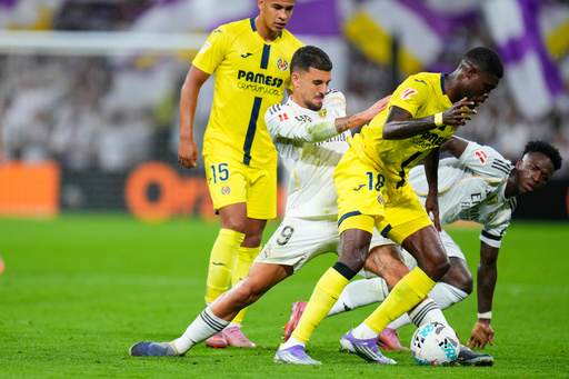 Real Madrid's Vinicius Junior, right, and Dani Ceballos, second from left, challenge for the ball with Villarreal's Santiago Mourino, left, and Pape Gueye during the Spanish La Liga soccer match between Real Madrid and Villarreal at the Santiago Bernabeu stadium in Madrid, Spain, Saturday, Oct. 4, 2025. (AP Photo/Manu Fernandez) Real Madrid's Vinicius Junior, right, and Dani Ceballos, second from left, challenge for the ball with Villarreal's Santiago Mourino, left, and Pape Gueye during the Spanish La Liga soccer match between Real Madrid and Villarreal at the Santiago Bernabeu stadium in Madrid, Spain, Saturday, Oct. 4, 2025. (AP Photo/Manu Fernandez)