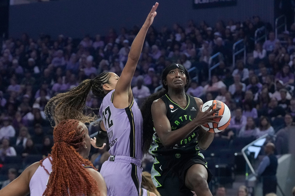 Seattle Storm guard Flau'jae Johnson, right, shoots against Golden State Valkyries guard Veronica Burton, middle, during the first half of a WNBA basketball game in San Francisco, Saturday, Sept. 19, 2026. (AP Photo/Jeff Chiu)