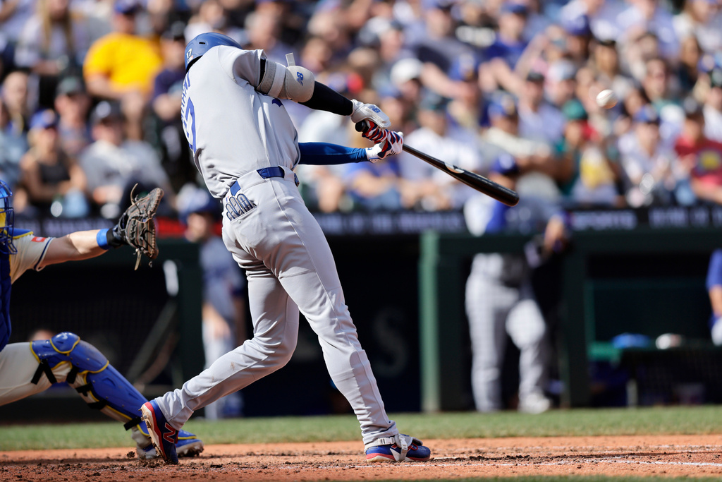 Los Angeles Dodgers' Shohei Ohtani hits a solo home run off Seattle Mariners pitcher Caleb Ferguson during the seventh inning of a baseball game Sunday, Sept. 28, 2025, in Seattle. (AP Photo/John Froschauer)