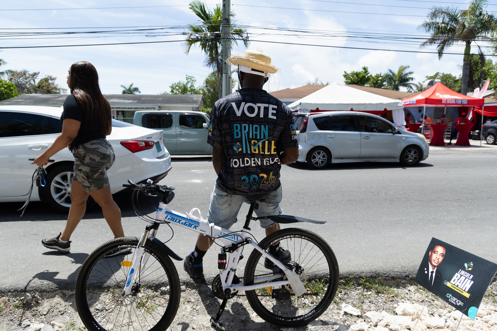 Voters arrive at a polling station to cast their ballots in the general election in Nassau, Bahamas, Tuesday, May 12, 2026. (AP Photo/Tim Aylen)