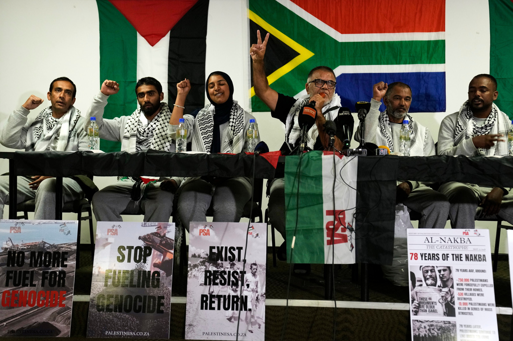 Activists gestures following their return home at OR Tambo International Airport, in Johannesburg, South Africa, Saturday, May 23, 2026. (AP Photo/Themba Hadebe)