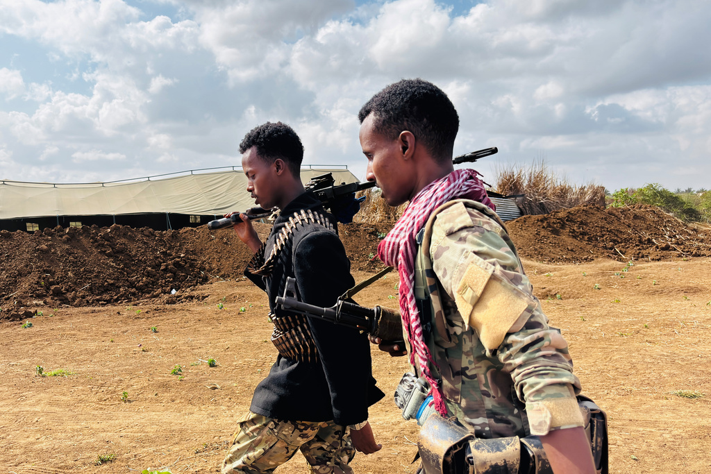 Somalia National Army (SNA) soldiers walk along the frontline in Sabiid, Canole, Somalia, Tuesday, Nov. 11, 2025. (AP Photo/Jackson Njehia)