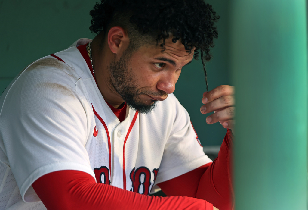 Boston Red Sox's Willson Contreras sits in the dugout after he grounded out in the eighth inning of a baseball game against the Athletics, Saturday, Aug. 8, 2026, in Boston. (AP Photo/Jim Davis)