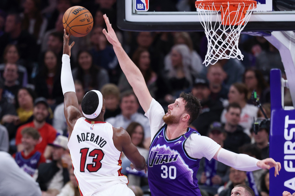 Miami Heat center Bam Adebayo (13) shoots the ball over Utah Jazz center Jusuf Nurkic (30) during the second half of an NBA basketball game, Saturday, Jan. 24, 2026, in Salt Lake City. (AP Photo/Rob Gray)