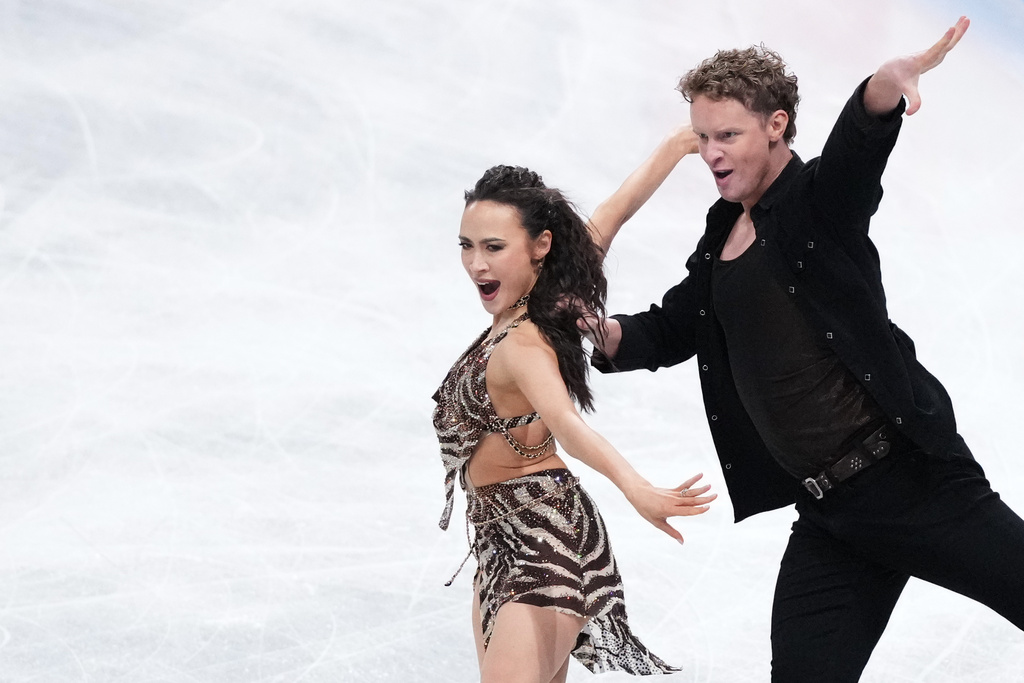 FILE - Madison Chock and Evan Bates, of the United States, compete in the ice dance's rhythm dance segment at the ISU Grand Prix of Figure Skating Final in Nagoya, central Japan, Thursday, Dec. 4, 2025. (AP Photo/Hiro Komae, File)