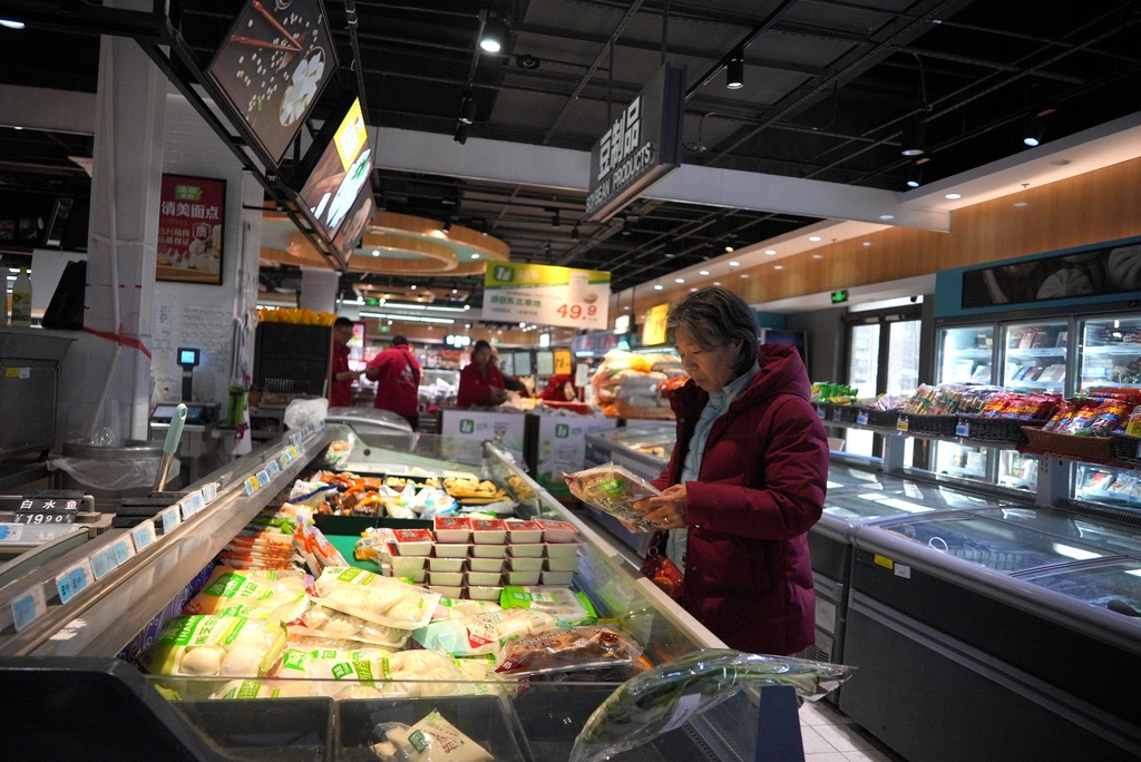 Residents shop for groceries at a store in the semi-abandoned "Life in Venice" housing complex in Qidong, on China's east coast, Feb. 5, 2026. (AP Photo/Dake Kang)