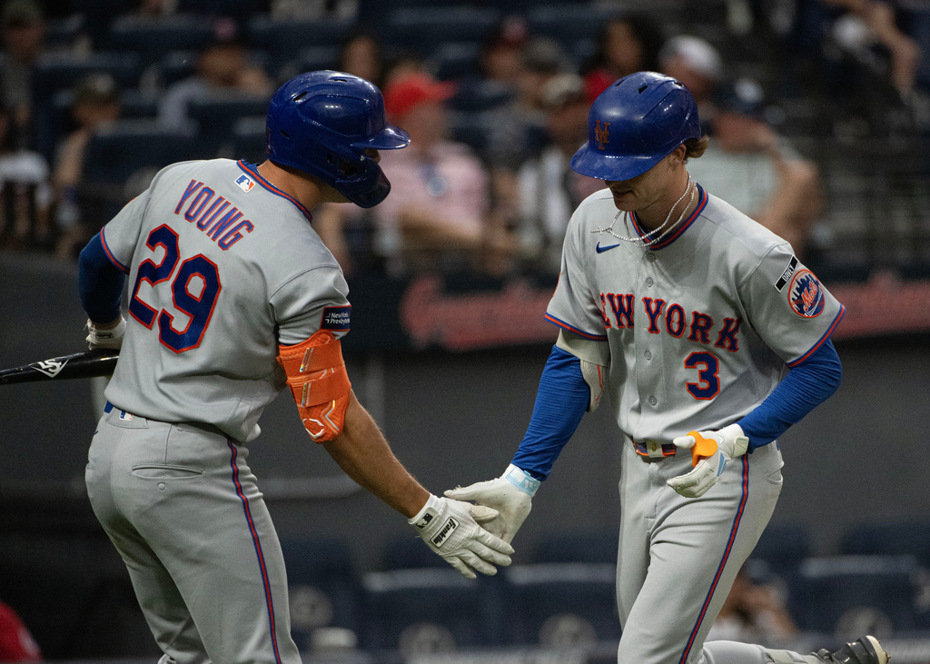 New York Mets' Jared Young (29) congratulates Dan Merzel (3) after his solo home run off Cleveland Guardians starting pitcher Tanner Bibee during the sixth inning of a baseball game, Wednesday, Aug. 5, 2026, in Cleveland. (AP Photo/Phil Long)
