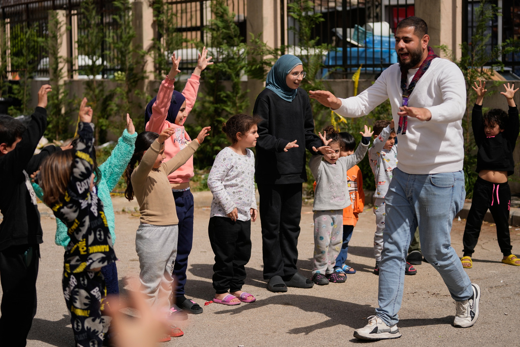 Displaced children who fled Israeli strikes from south Lebanon, take part in activities at a school turned shelter, in the southern port city of Sidon, Lebanon, Wednesday, March 18, 2026. (AP Photo/Mohammed Zaatari)