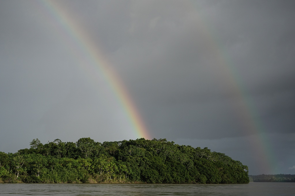 Rainbows cross the Putumayo River on the outskirts of Puerto Asis, Colombia, Wednesday, Nov. 26, 2025. (AP Photo/Ivan Valencia)