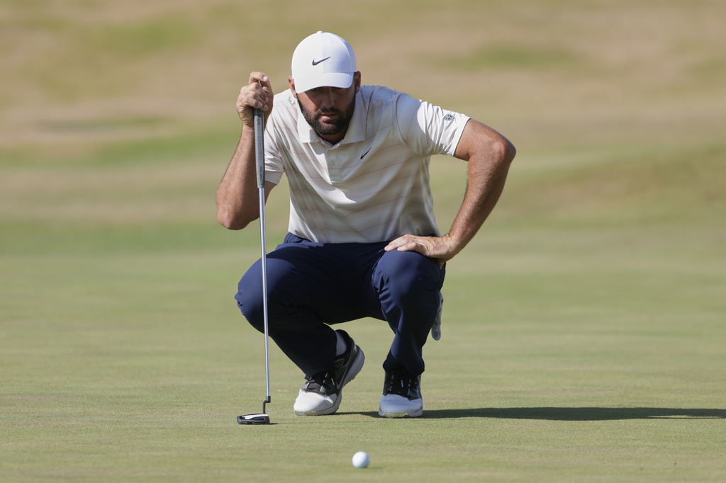 Scottie Scheffler of the United States looks at the lie of his putt on the 18th green during the final day of the British Open Golf championships at Royal Birkdale golf club, in Southport, England, Sunday, July 19, 2026. (AP Photo/Peter Morrison)