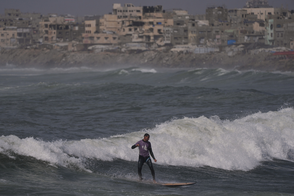 Palestinian Tahseen Abu Assi rides a wave at a beach along the Mediterranean Sea in Gaza City, Monday, May 4, 2026. (AP Photo/Jehad Alshrafi)