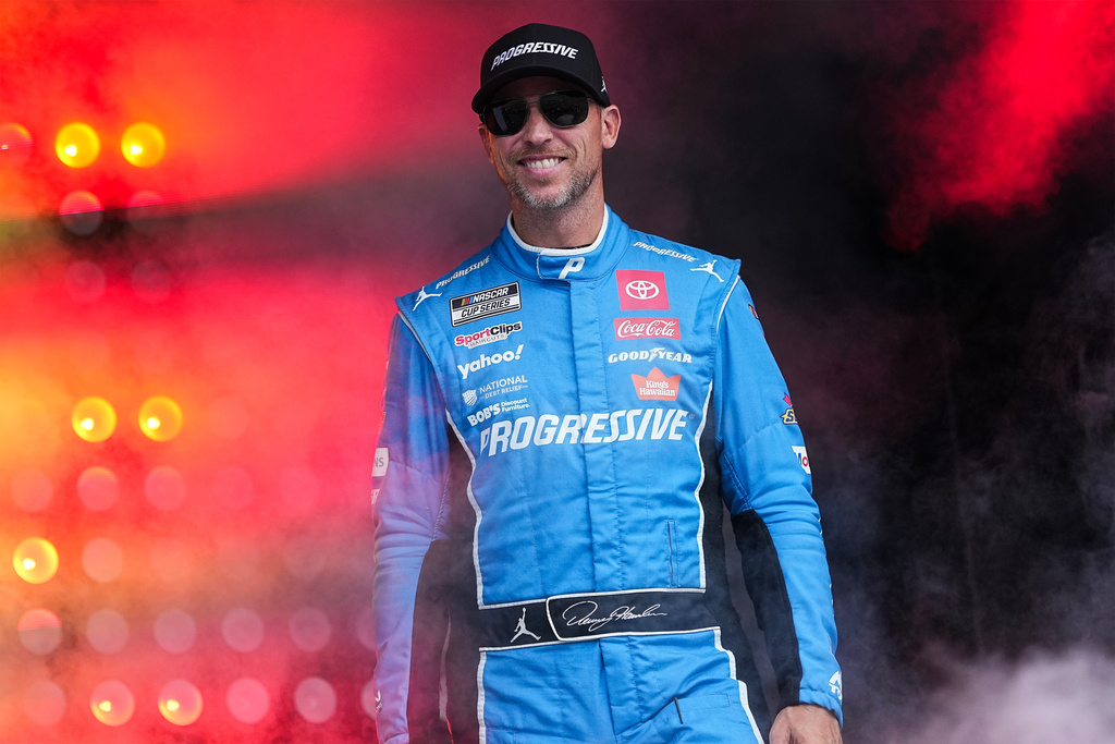 FILE - Denny Hamlin smiles prior to a NASCAR Cup Series auto race at Charlotte Motor Speedway, Oct. 5, 2025, in Concord, N.C. (AP Photo/Matt Kelley, File)