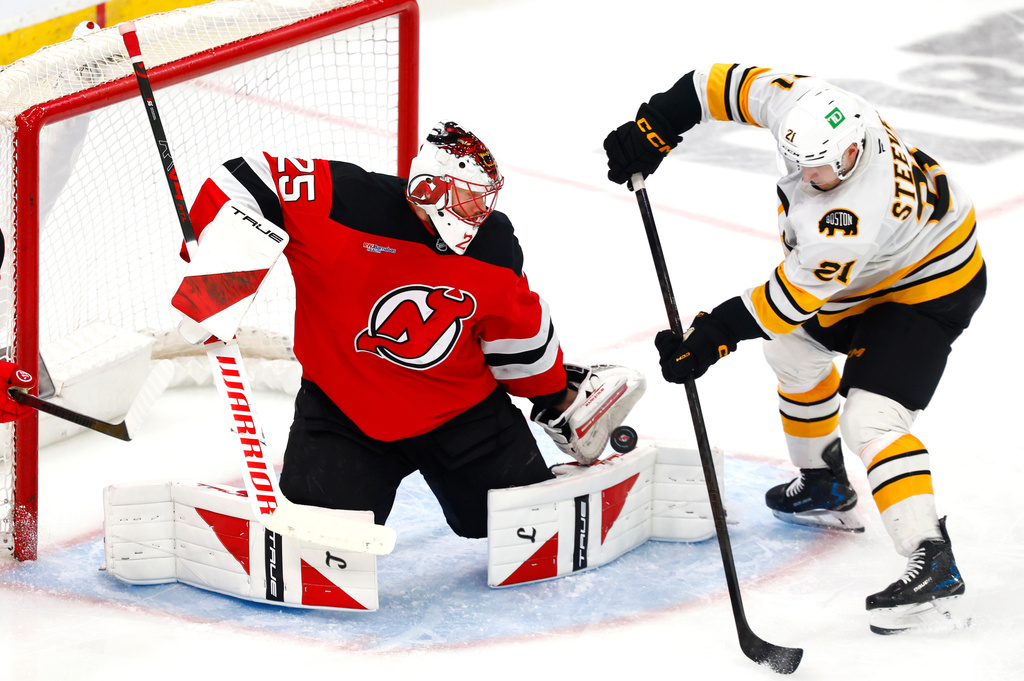 FILE - New Jersey Devils goaltender Jacob Markstrom (25) makes a save against Boston Bruins forward Alex Steeves (21) during the third period of an NHL hockey game, March 16, 2026, in Newark, N.J. (AP Photo/Noah K. Murray, File)