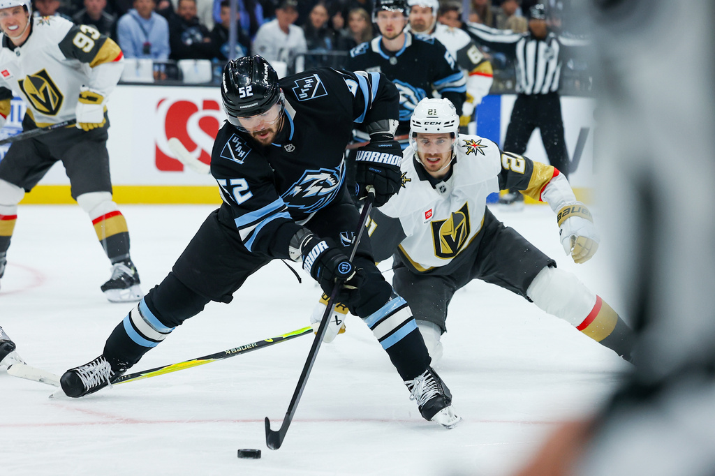 Utah Mammoth defenseman MacKenzie Weegar (52) controls the puck against Vegas Golden Knights center Brett Howden (21) during the first period of Game 6 in the first round of an NHL hockey Stanley Cup playoff series, Friday, May 1, 2026, in Salt Lake City. (AP Photo/Melissa Majchrzak)