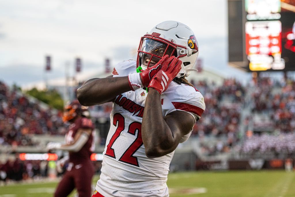 Louisville running back Keyjuan Brown (22) reacts after a touchdown against Virginia Tech during the second half of an NCAA college football game, Saturday, Nov. 1, 2025, in Blacksburg, Va. (AP Photo/Robert Simmons)