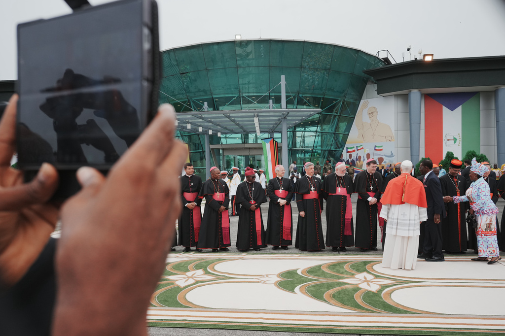 Pope Leo XIV is welcomed by Equatorial Guinea's President Teodoro Obiang Nguema Mbasogo, fifth from right, and his wife, second from right, Constancia Mangue de Obiang, upon his arrival at Malabo International Airport in Malabo, Equatorial Guinea, Tuesday, April 21, 2026, on the ninth day of his 11-day pastoral visit to Africa. (AP Photo/Andrew Medichini)
