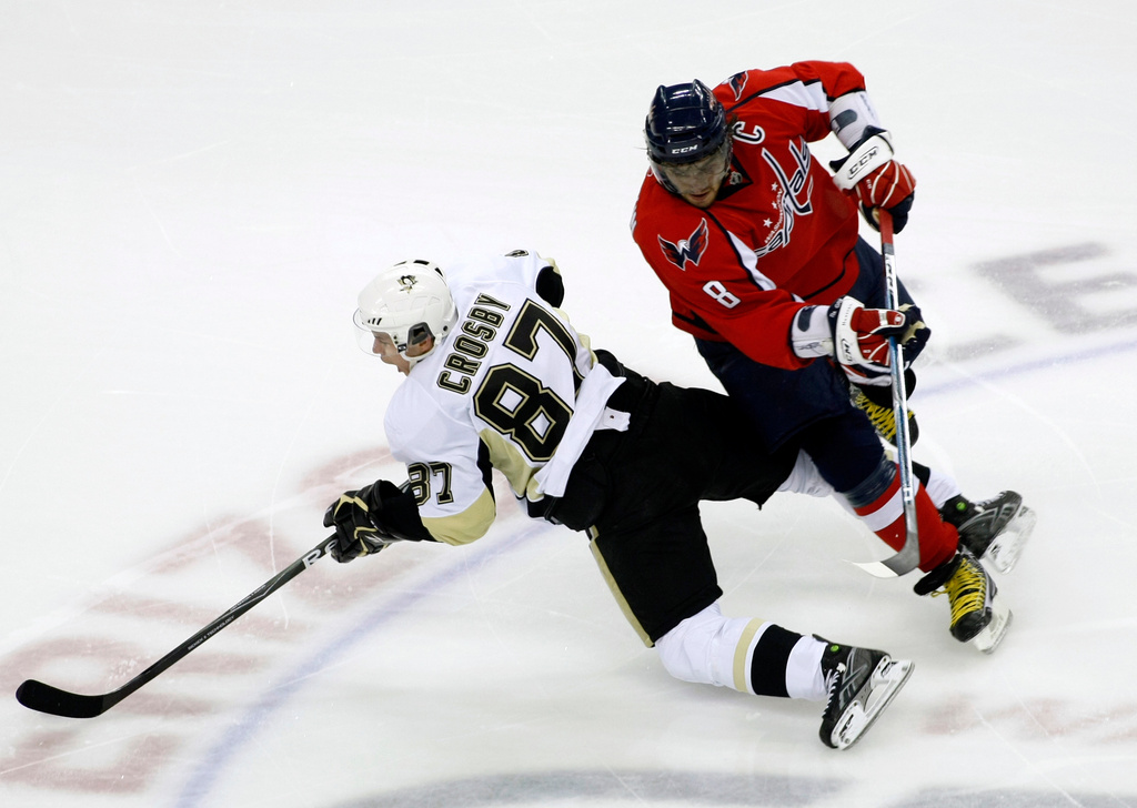 FILE - In this Sunday, Feb. 7, 2010 file photo, Washington Capitals' Alex Ovechkin (8), of Russia, runs into Pittsburgh Penguins' Sidney Crosby (87) during the second period of an NHL hockey game, in Washington. (AP Photo/Luis M. Alvarez, File)