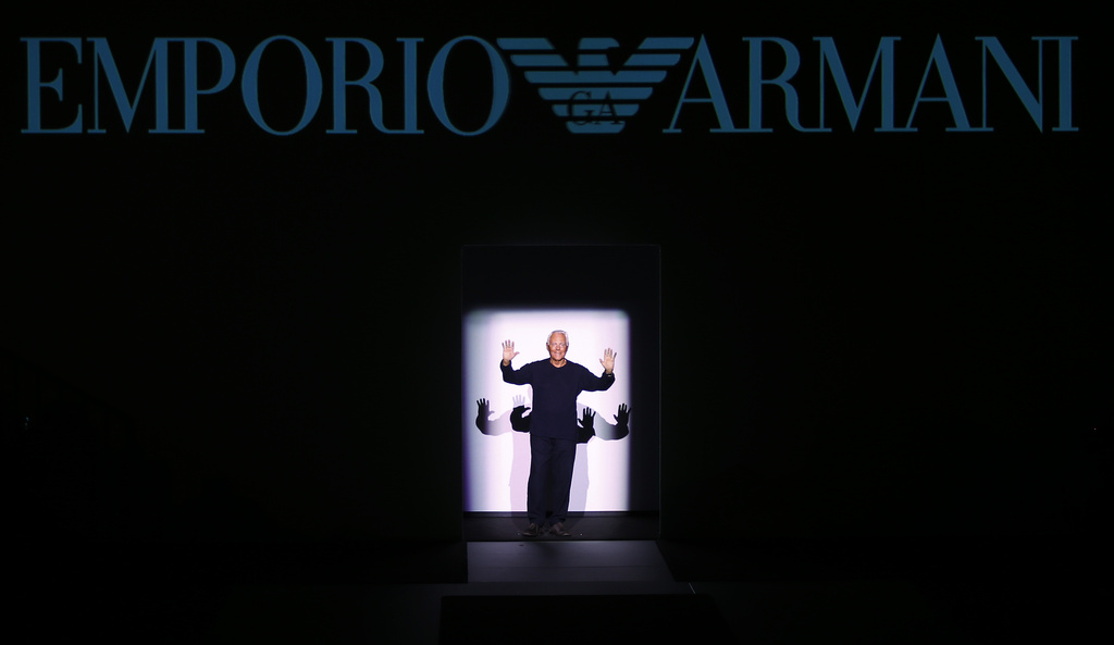FILE - Fashion designer Giorgio Armani acknowledges the applause after presenting his Emporio Armani men's Fall-Winter 2017-2018 collection, part of the Milan Fashion Week, unveiled in Milan, Italy, Saturday, Jan. 14, 2017. (AP Photo/Antonio Calanni, File)