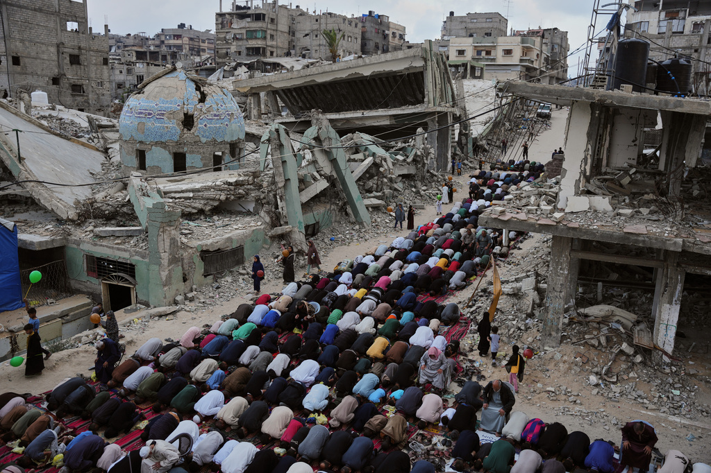 Palestinians offer Eid al-Adha prayers beside the ruins of a mosque destroyed by Israeli bombardment, in Khan Younis, southern Gaza Strip, Wednesday, May 27, 2026. (AP Photo/Abdel Kareem Hana)