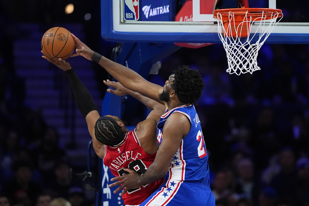 Philadelphia 76ers' Joel Embiid, right, blocks a shot by Chicago Bulls' Guerschon Yabusele during the first half of an NBA basketball game Wednesday, March 25, 2026, in Philadelphia. (AP Photo/Matt Slocum)