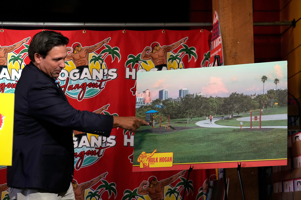 Florida Gov. Ron DeSantis displays an artist rendition of a fitness trail in honor of wrestling legend Hulk Hogan Friday, Oct. 3, 2025, in Clearwater, Fla. (AP Photo/Chris O'Meara)